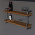 Wooden shelf with metal pipes holding wine bottles and glasses against a gray background