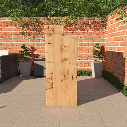 Wooden planter against a brick wall with potted plants on a patio