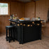 Black wooden bar with string lights in a rustic room with a window and chair.