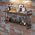 Wooden bar shelf with bottles, glasses, and a clock against a brick wall.