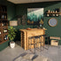 Modern home bar with wooden counter, stools, and decorative elements against a green wall.