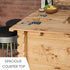Wooden outdoor counter with drinks and a phone on a blurred background