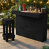Black outdoor bar with drinks and a stool on a patio