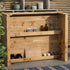 Wooden outdoor bar with various items on shelves against a neutral background