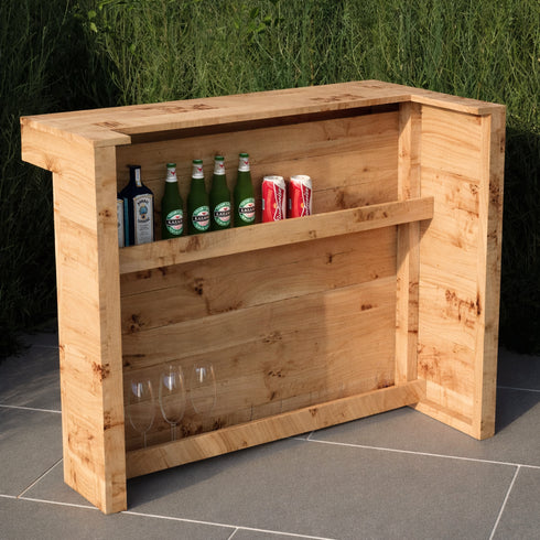 Wooden bar cart with drinks and glasses on a tiled floor outdoors.