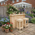 Wooden outdoor bar set with stools in a garden setting